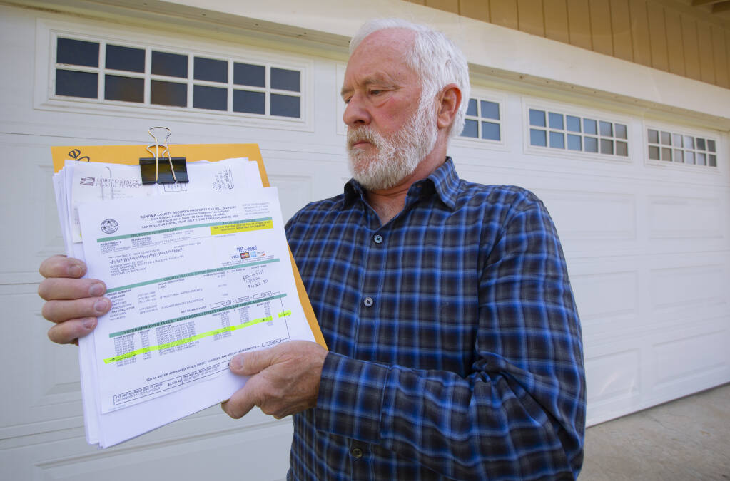 Sonoma resident Scott Pace with his property tax papers, the line item for the Sonoma Valley County Sanitation District highlighted. He’s been keeping a keen eye on the charges since 2013, the first time there was a mistake in sanitation district billing. (Photo by Robbi Pengelly/Index-Tribune)