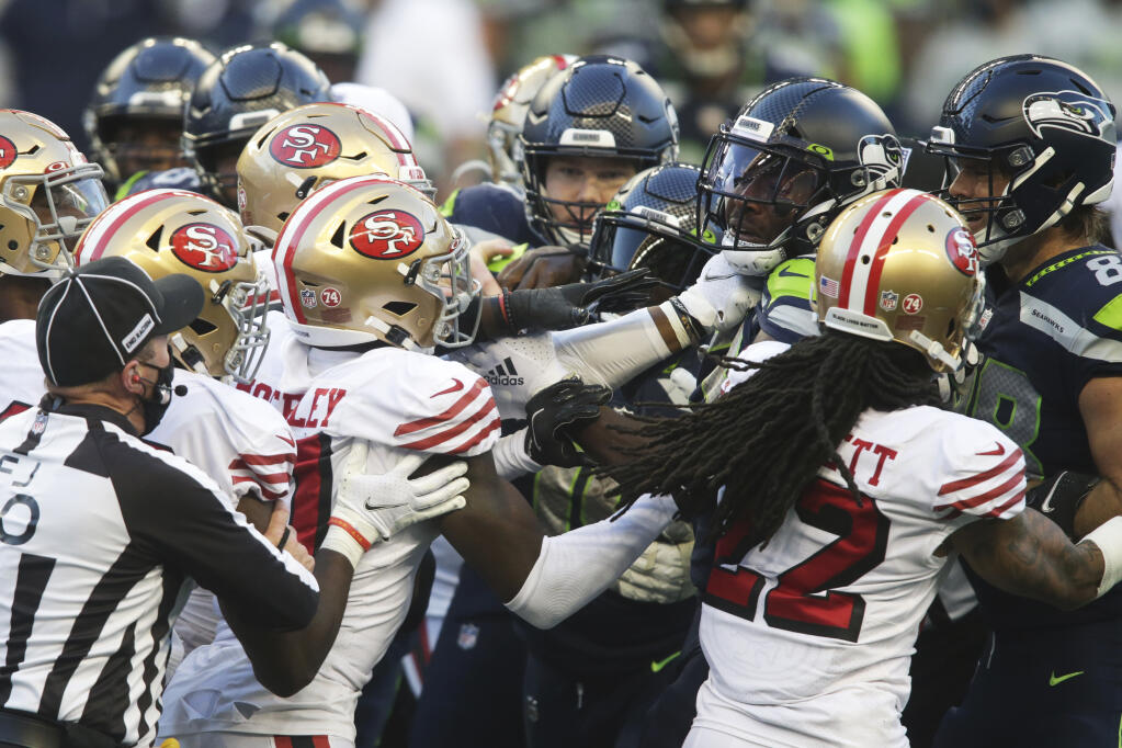 Seattle Seahawks and San Francisco 49ers players scuffle after a personal foul was called on a late hit to quarterback Russell Wilson during the second half on Sunday, Nov. 1, 2020, in Seattle. The Seahawks won 37-27. (Scott Eklund / ASSOCIATED PRESS)