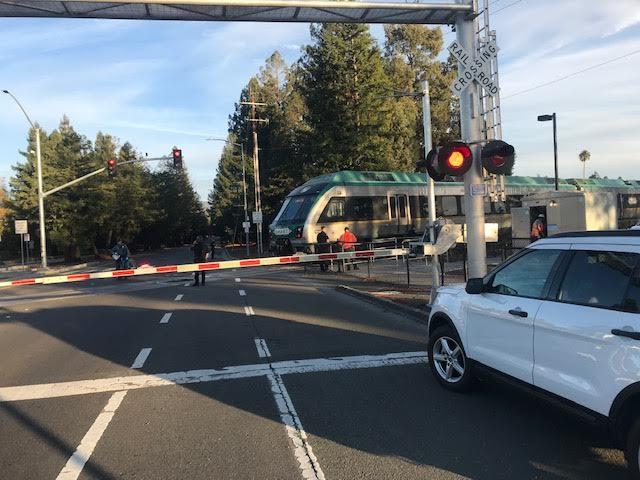 First responders working at the intersection of Rohnert Park Expressway and the SMART train tracks, where a bicyclist collided with a train at 3:45 p.m. Tuesday, Nov. 21, 2023,  according to a SMART official. The cyclist was injured, but not fatally (Austin Murphy / The Press Democat)