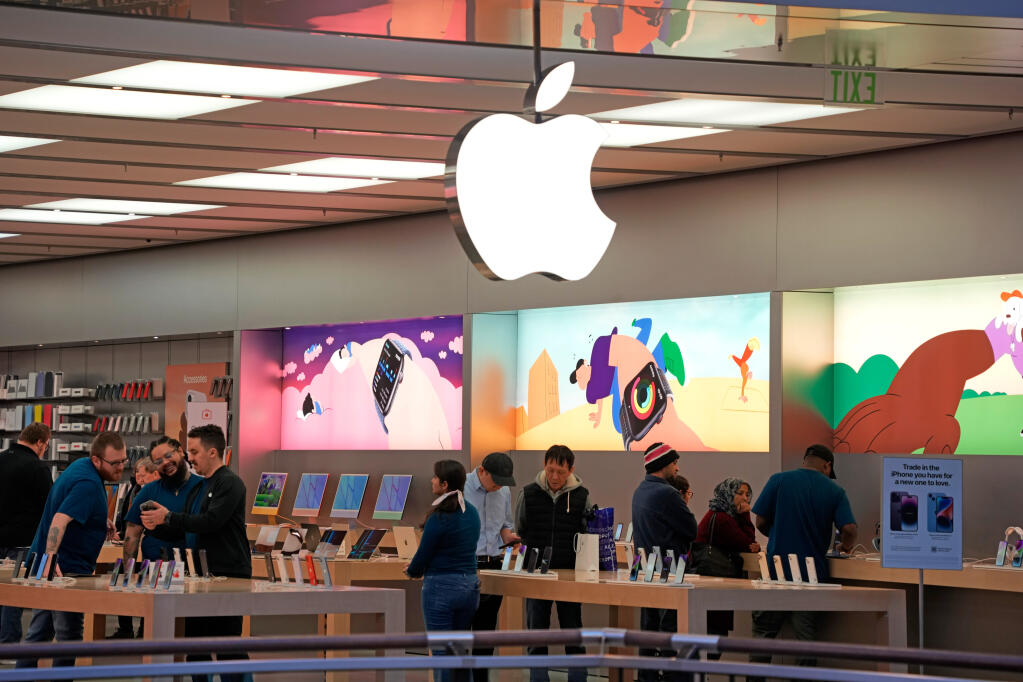 Customers shop in an Apple store in Pittsburgh Jan. 30, 2023. (AP Photo/Gene J. Puskar, File)