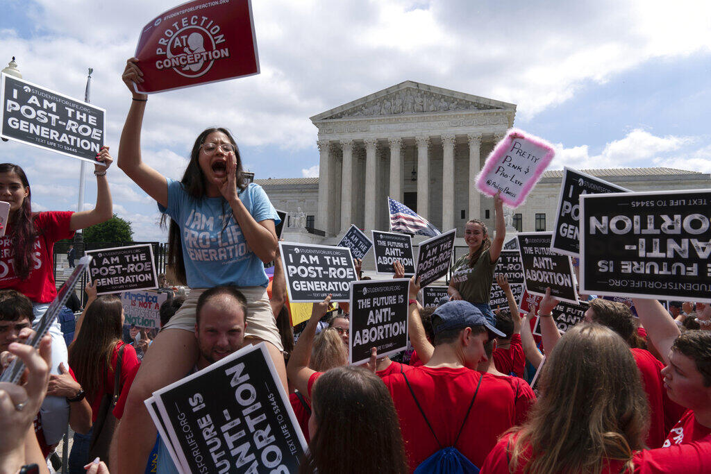 Anti-abortion protesters celebrate outside the Supreme Court after the justices overturned Roe v. Wade, ending constitutional protection for abortions. (JOSE LUIS MAGANA / Associated Press)