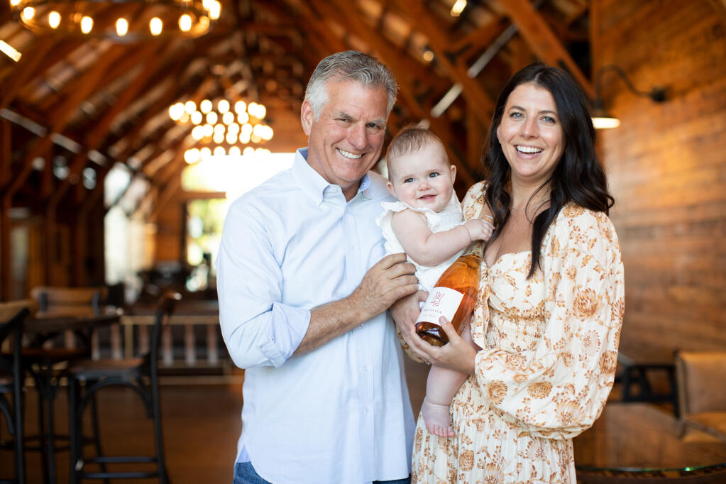 Bricoleur Vineyards founder Mark Hanson, left, and daughter and co-founder Sarah Hanson Citron hold Sarah’s daughter, Isla Rose. The winery will donate $5 from every bottle of Isla Rose Brut Rosé sold in October to the V Foundation for cancer research, as Citron battles her own breast cancer diagnosis. (Bricoleur Vineyards)