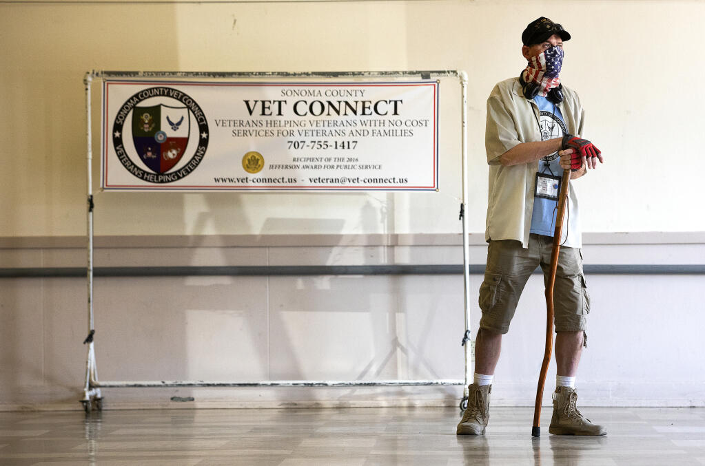 A Vet Connect volunteer waits by the door to check in clients at the Santa Rosa Veteran's Memorial Building on Tuesday, Sept.14, 2021. The group, which offers resources, doughnuts, coffee and a place to gather each week, has seen a lag in the number of clients since reopening. (John Burgess/The Press Democrat)