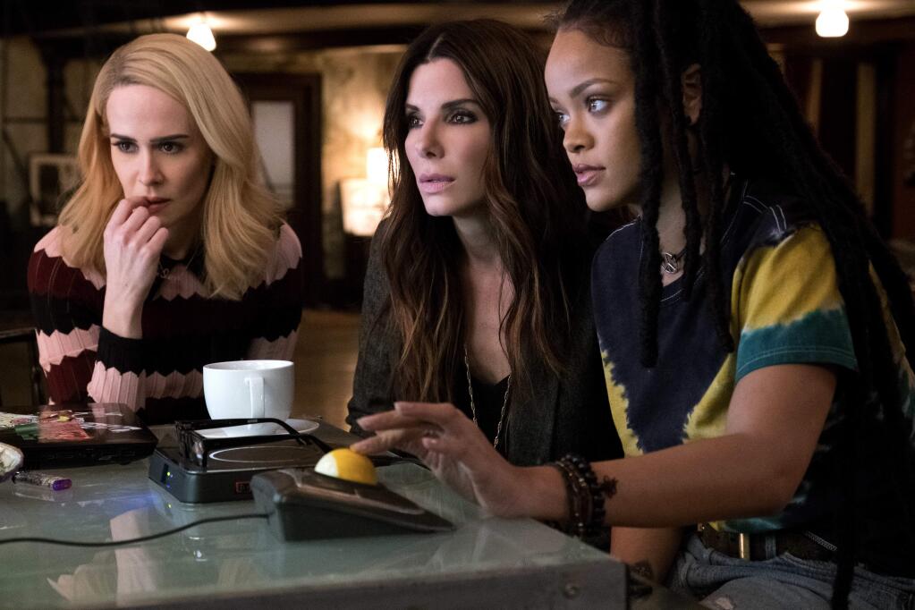 This image released by Warner Bros. shows Sarah Paulson, from left, Sandra Bullock and Rihanna in a scene from 'Ocean's 8.' (Barry Wetcher/Warner Bros. via AP)