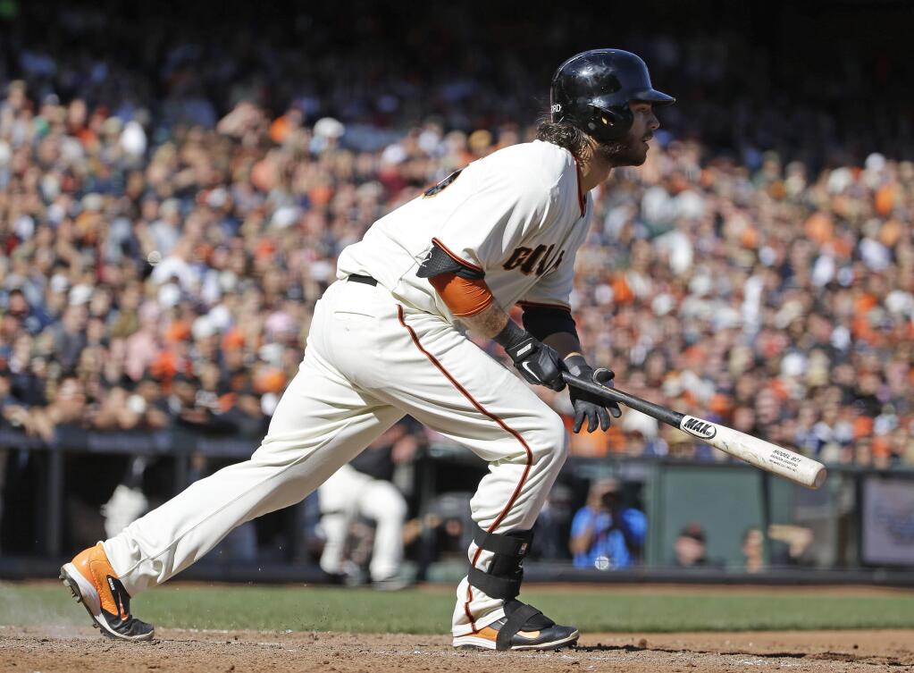 San Francisco Giants' Brandon Crawford hits a two-run single off San Diego Padres relief pitcher Dale Thayer in the eighth inning of their baseball game Saturday, Sept. 27, 2014, in San Francisco. San Francisco won the game 3-1. (AP Photo/Eric Risberg)
