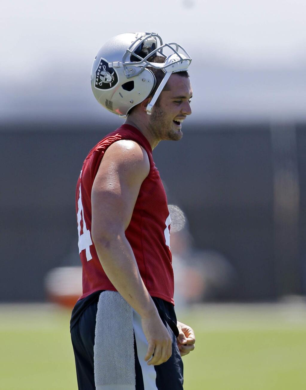 Oakland Raiders quarterback Derek Carr laughs during a break in practice on Tuesday, June 13, 2017, at the team's training facility in Alameda. (AP Photo/Ben Margot)