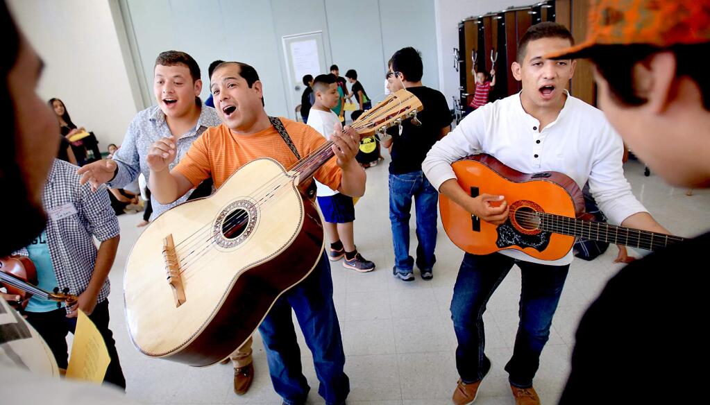 From left, Jose Soto, Carlos Soto and Alejandro Montoya practice the art of hitting high notes as they instruct children during Mariachi Camp at Cook Junior High, Monday July 27, 2015 in Santa Rosa. (Kent Porter / Press Democrat) 2015