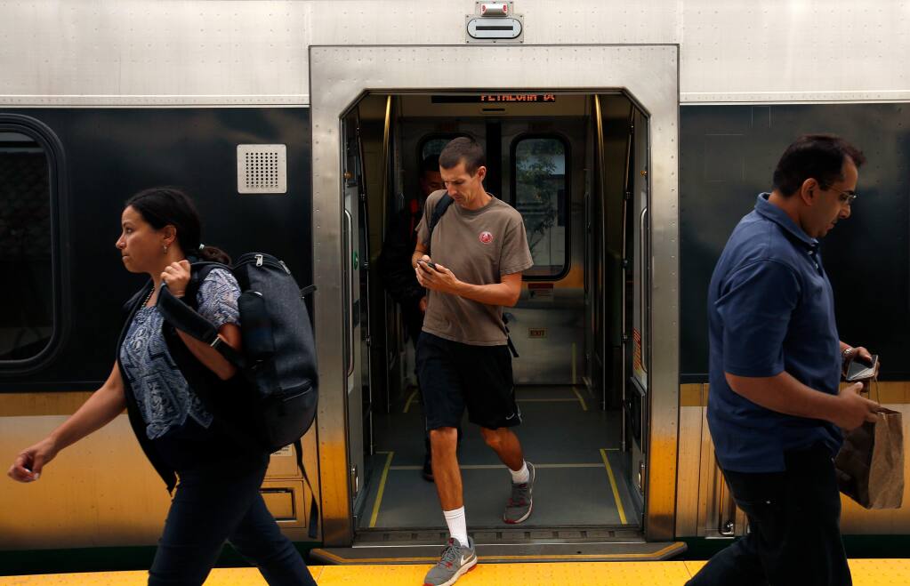 Commuters disembark the SMART train in Petaluma, California, on Wednesday, September 20, 2017. (Alvin Jornada / The Press Democrat)