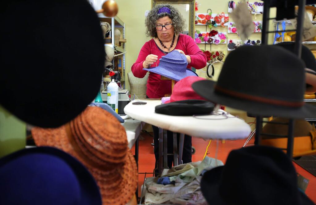 Amy Smith works on stitching a hat at her Flying Color Studios in Santa Rosa, on Friday, April 1, 2016. (Christopher Chung/ The Press Democrat)