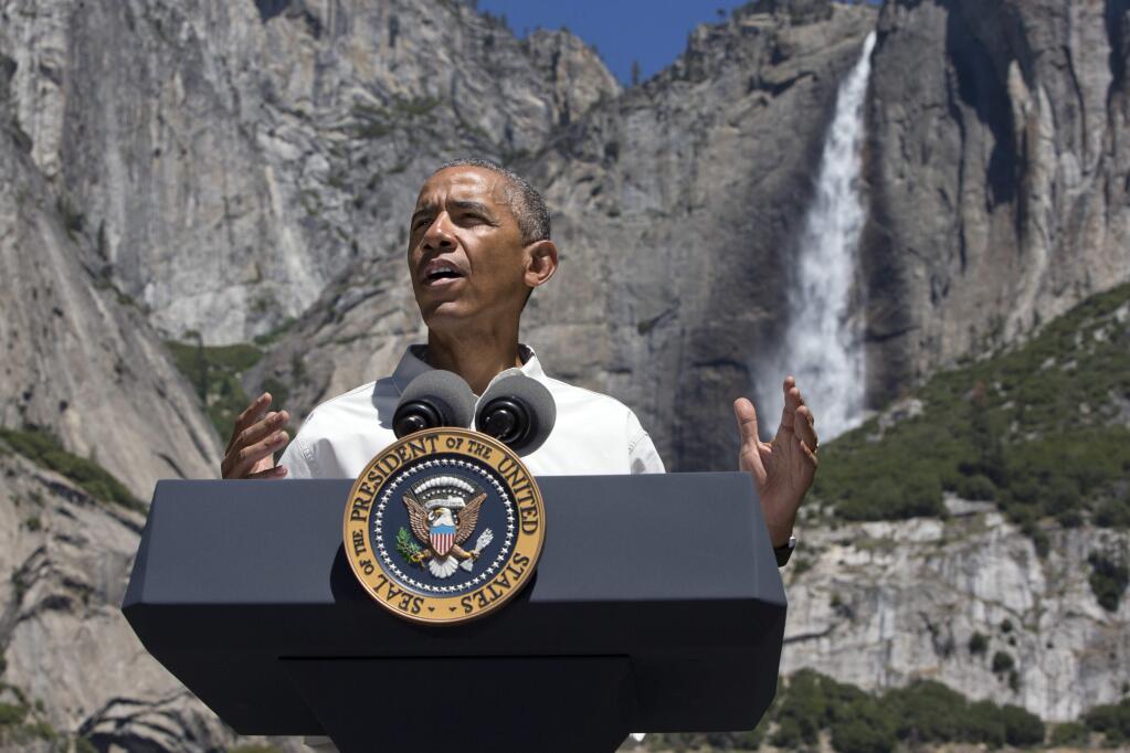 President Barack Obama speaks by the Sentinel Bridge in front of Yosemite Falls, the highest waterfall in Yosemite National Park. (JACQUELYN MARTIN / Associated Press)