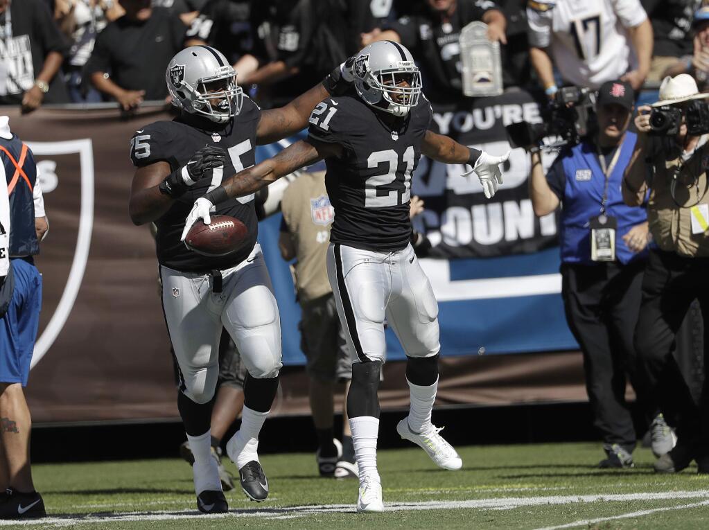 Oakland Raiders cornerback Sean Smith (21) celebrates after intercepting a pass against the San Diego Chargers during the first half of an NFL football game in Oakland, Calif., Sunday, Oct. 9, 2016. (AP Photo/Marcio Jose Sanchez)
