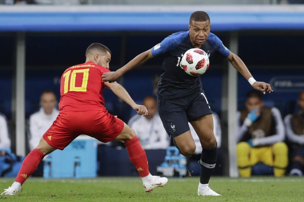 Belgium's Eden Hazard, left, challenges France's Kylian Mbappe during the semifinal match between France and Belgium at the 2018 World Cup in the St. Petersburg Stadium, in St. Petersburg, Russia, Tuesday, July 10, 2018. (AP Photo/Petr David Josek)