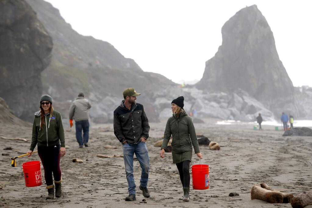 Gia Baiocchi, left, a board member of the B-Rad Foundation, Noah Churma and Kaelyn Ramsden walk along the beach and pick up trash during the Sonoma Coast Stewardship Day at Goat Rock Beach in Jenner, on Saturday, February 4, 2017. (BETH SCHLANKER/ The Press Democrat)
