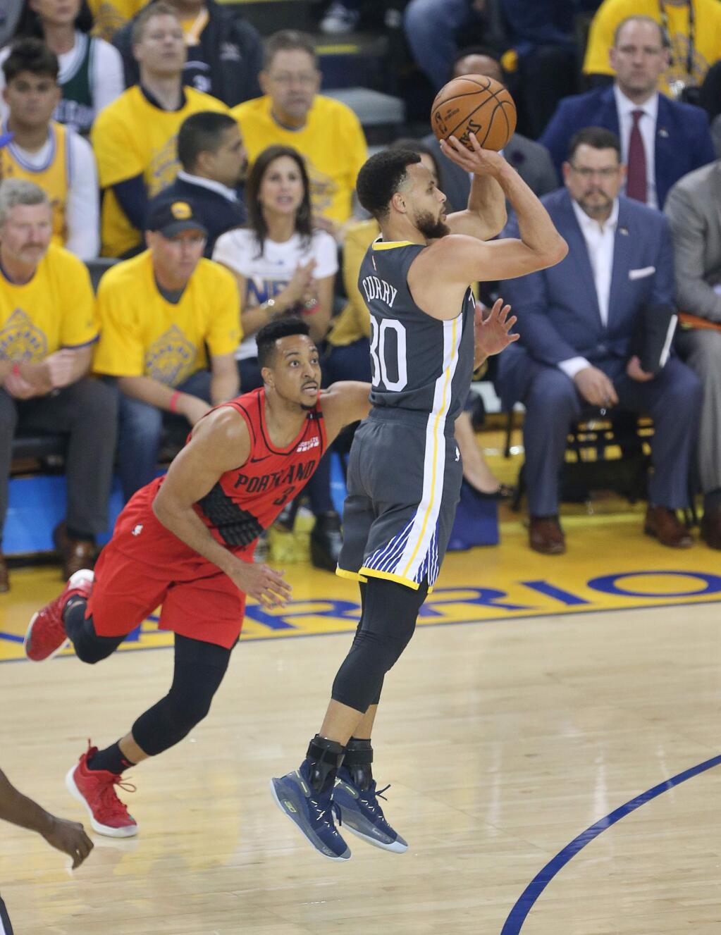 Golden State Warriors guard Stephen Curry shoots a three-pointer against Portland Trail Blazers guard CJ McCollum during game 2 of the NBA Western Conference Finals in Oakland on Thursday, May 16, 2019. (Christopher Chung/ The Press Democrat)