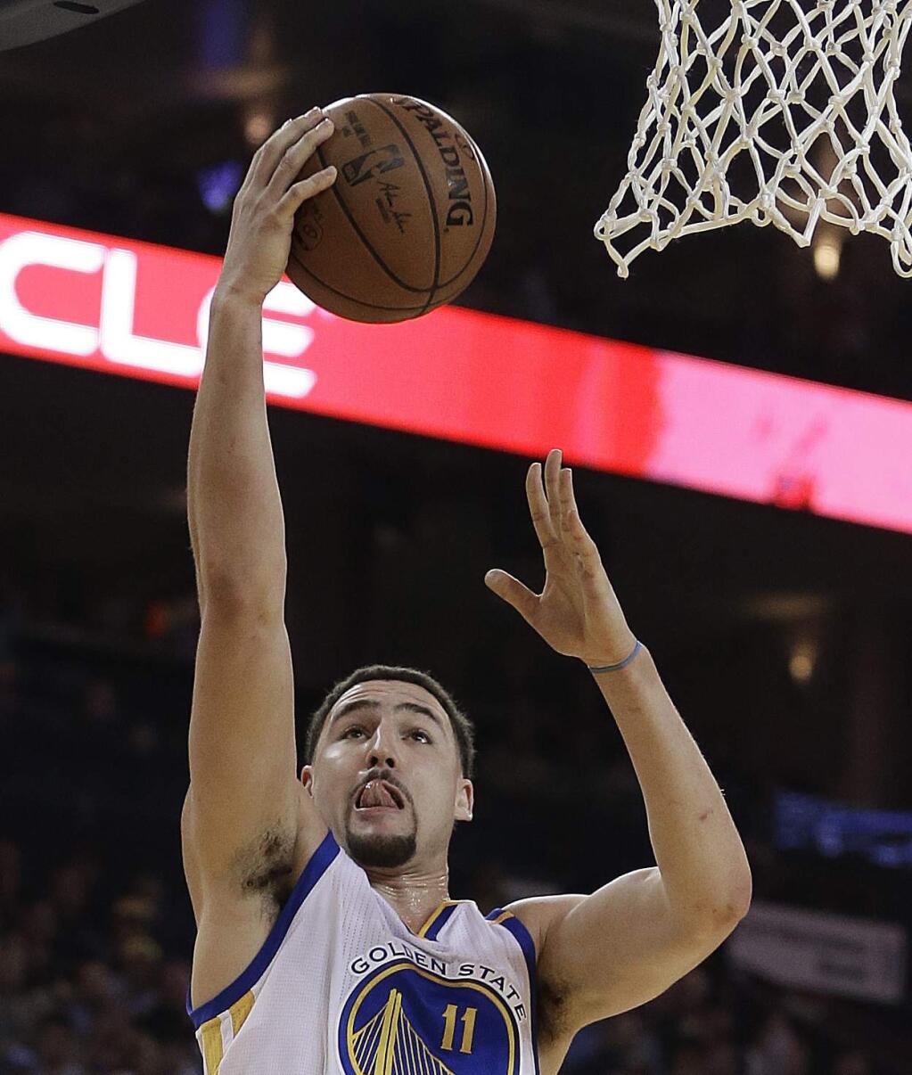 Golden State Warriors' Klay Thompson lays up a shot against the Sacramento Kings during the first half of an NBA basketball game Wednesday, Feb. 15, 2017, in Oakland, Calif. (AP Photo/Ben Margot)