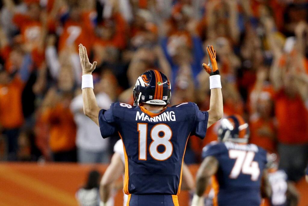 Denver Broncos quarterback Peyton Manning (18) signals a touchdown after throwing his 508th career touchdown pass during the first half of an NFL football game against the San Francisco 49ers, Sunday, Oct. 19, 2014, in Denver. (AP Photo/Brennan Linsley)