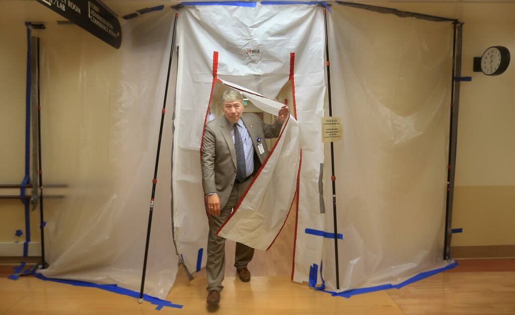 Sonoma West Medical Center CEO Raymond Hino emerges from a construction area at Palm Drive Hospital in Sebastopol as remodeling continues prior to the re-opening of the hospital, Monday March 2, 2015. (Kent Porter / Press Democrat) 2015