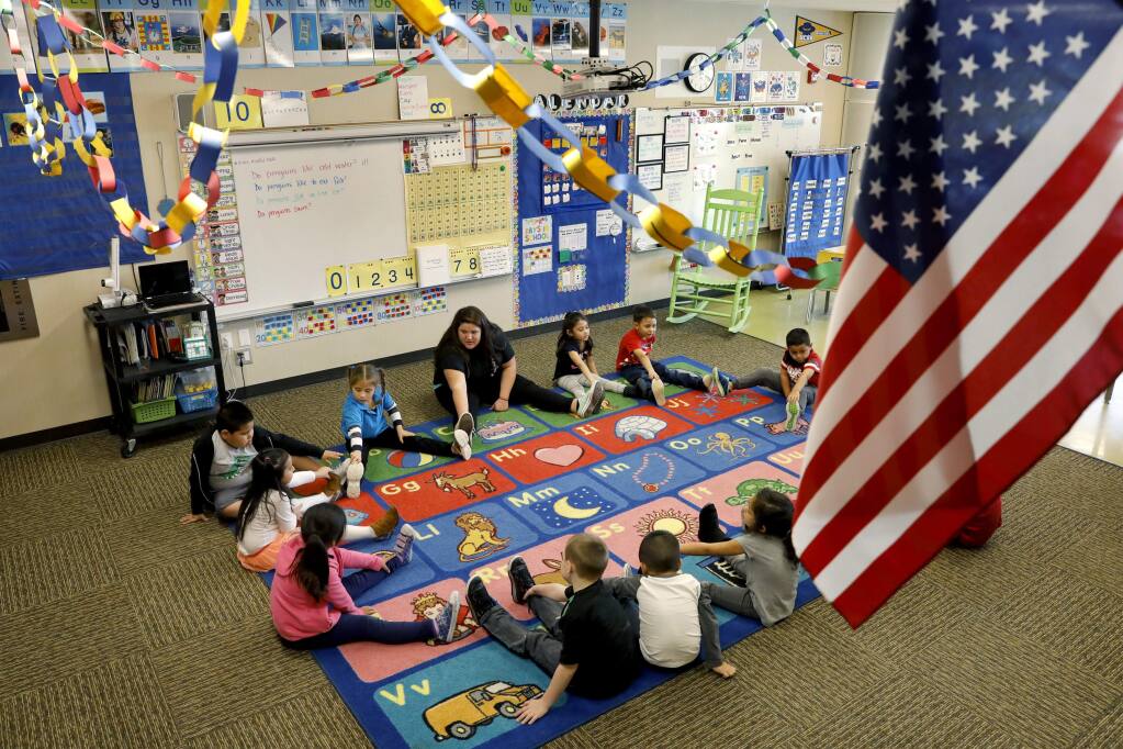Kindergarten teacher Jaime Wanke leads a class of only 13 students, out of her usual 22, in stretches at Roseland Creek Elementary School in Santa Rosa, Thursday, Feb. 16, 2017. About 40 percent of the school's student body was absent Thursday.(BETH SCHLANKER/ The Press Democrat)