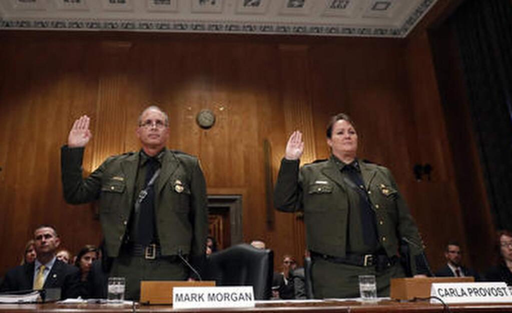 FILE - In this Nov. 30, 2016 file photo, Customs and Border Protection U.S. Border Patrol Chief Mark Morgan, left, and Deputy Chief Carla Provost, are sworn in during a hearing of the Senate Committee on Homeland Security and Governmental Affairs concerning border protection on Capitol Hill in Washington. Ronald Vitiello now acting deputy commissioner of Customs and Border Protection has named his deputy, Carla Provost, acting Border Patrol chief. She is the first woman to lead the agency. (AP Photo/Alex Brandon, File)