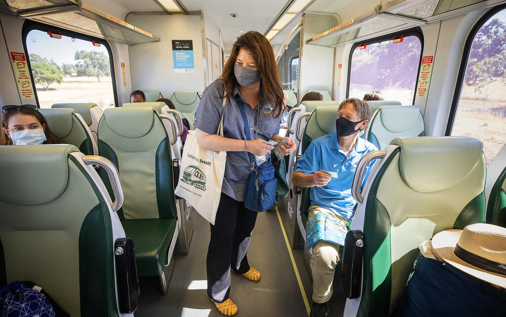 SMART train CFO Heather McKillop hands out free tickets to celebrate the commuter train’s 2 millionth passenger on Wednesday, June 23, 2021.  (Photo by John Burgess/The Press Democrat)