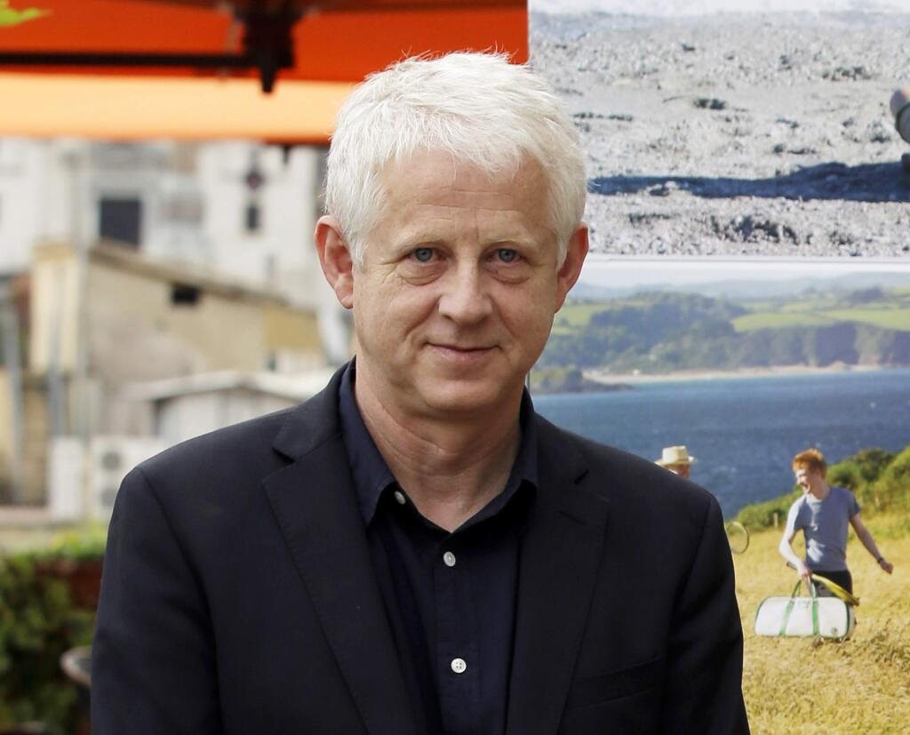 FILE - In this Oct. 21, 2013 file photo, British director Richard Curtis poses for the photographers as he present his latest movie 'About Time' , in Rome. Thirty years ago, Curtis suspected two things: People like to laugh and they like to do good. Red Nose Day has annually proved him right in the United Kingdom, where more than $1 billion has been raised to fight childhood poverty. Now Curtis is bringing Red Nose Day to the United States with a star-studded three-hour TV event airing Thursday, May 21, 2015. (AP Photo/Gregorio Borgia, FIle)