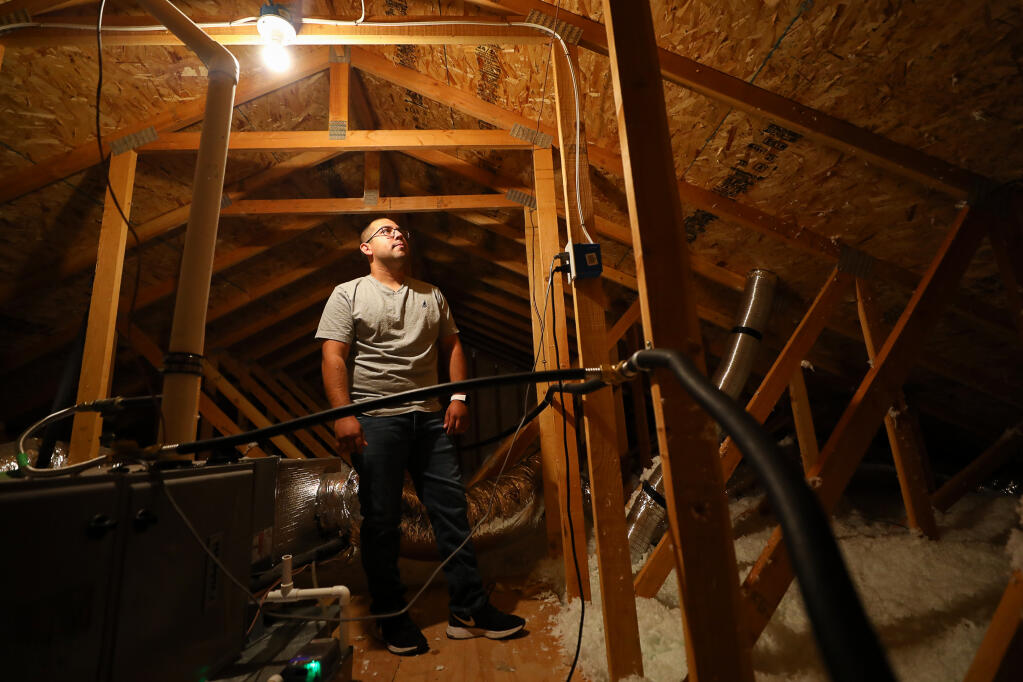 Miguel Hernandez and his family have been living in their rebuilt Coffey Park area home under a temporary occupancy permit for the past  2½ years.  The contractor that built the home failed to install radiant barriers and adequate insulation in the attic. (Christopher Chung/ The Press Democrat)