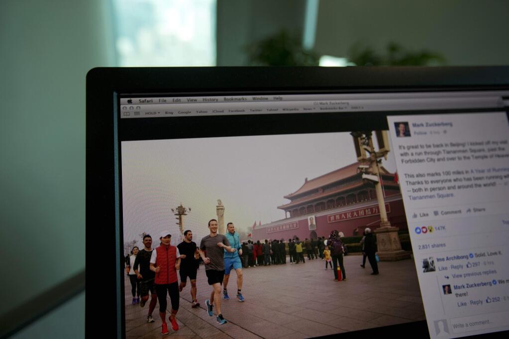 A computer screen displays the social media posting by Mark Zuckerberg on Facebook in Beijing, China, Friday, March 18, 2016. The photo of Facebook founder Mark Zuckerberg jogging in downtown Beijings notorious smog has prompted a torrent of astonishment, mockery and amusement on Chinese social media. (AP Photo/Ng Han Guan)
