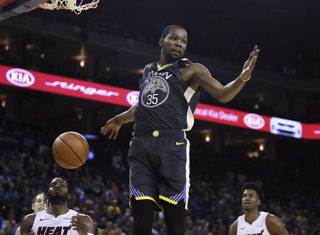 The Golden State Warriors' Kevin Durant scores against the Miami Heat during the second half, Sunday, Feb. 10, 2019, in Oakland. (AP Photo/Ben Margot)