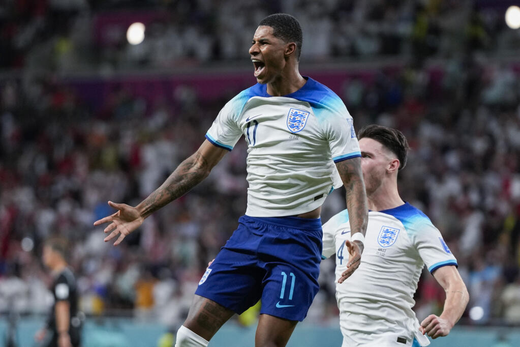England’s Marcus Rashford celebrates after scoring the opening goal against Wales during Tuesday’s World Cup game in Al Rayyan, Qatar. (Frank Augstein / ASSOCIATED PRESS)