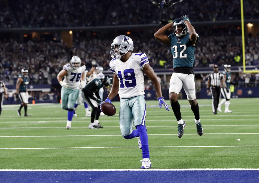 Dallas Cowboys wide receiver Amari Cooper scores a 15-yard touchdown as the Philadelphia Eagles' Rasul Douglas watches in overtime in Arlington, Texas, Sunday, Dec. 9, 2018. Dallas won 29-23. (AP Photo/Roger Steinman)