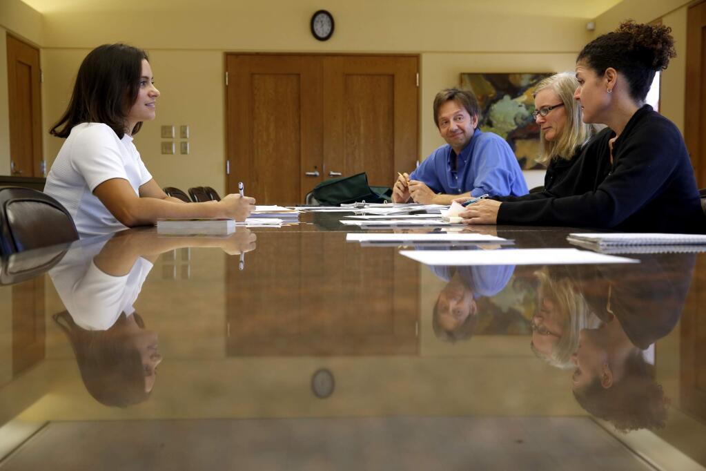 Leonela Santiago, left, founder of Lingua Franca Academy, teaches Spanish to English speaking employees Brian Calcagno, Cara Morrison and Angela Lucero at Sonoma-Cutrer Vineyards in Windsor on Monday, Aug. 11, 2014. (BETH SCHLANKER / The Press Democrat)