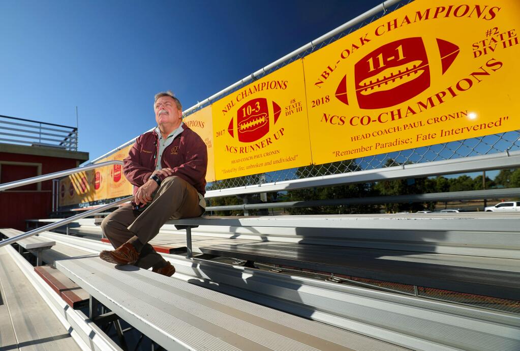 Graham Rutherford, Cardinal Newman dean of student life, said the school wanted to memorialize their recovery from the Tubbs fire, and the Paradise fire. Signs at the top of the bleachers commemorate both of the events.(Christopher Chung/ The Press Democrat)