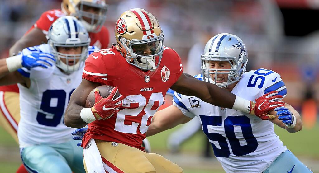 Carlos Hyde attempts to break free of Sean Lee of the Cowboys as he pushes for extra yardage during the 49ers loss to Dallas, 24-17, Sunday Oct. 2, 2016 at Levi's Stadium in Santa Clara. (Kent Porter / The Press Democrat) 2016