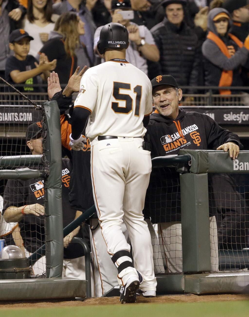San Francisco Giants manager Bruce Bochy, right, smiles at Mac Williamson (51) after Williamson hit a home run against the Boston Red Sox during the eighth inning of a baseball game Wednesday, June 8, 2016, in San Francisco. (AP Photo/Ben Margot)