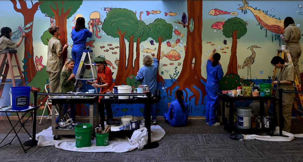 Sonoma Academy students and Sutter Pacific Medical Foundation Care Center personnel work on a 300-square-foot mural inside the facility on Airway Drive, Friday, Jan. 5, 2024 in Santa Rosa. (Kent Porter / The Press Democrat) 2024