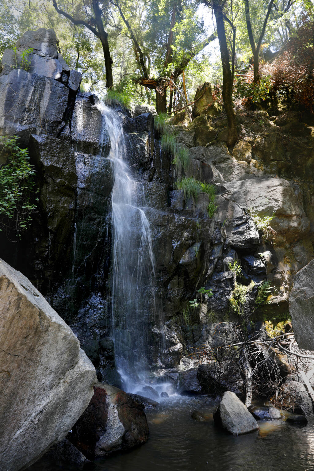 Water falls down a cascade of rocks at Linda Falls Preserve in Angwin, Wednesday, July 19, 2023. (Beth Schlanker / The Press Democrat)