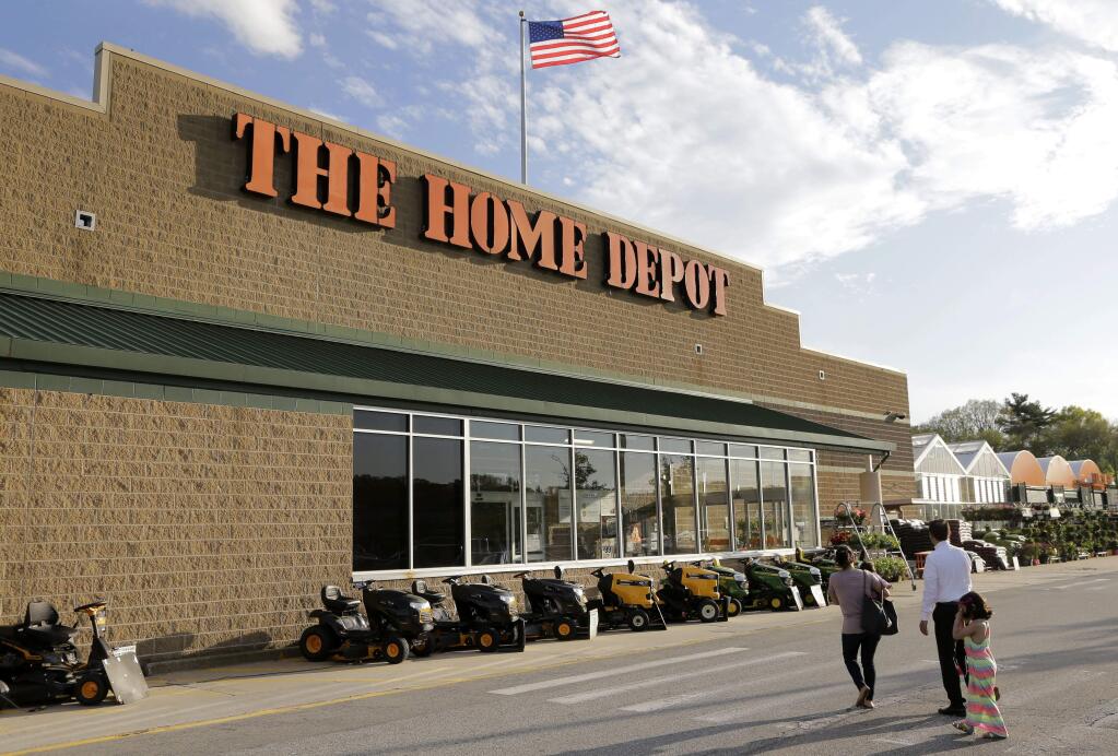 FILE - In this May 18, 2016, file photo, people approach an entrance to a Home Depot store in Bellingham, Mass. Home Depot will pay $27 million to settle charges in California that the retailer illegally disposed of hazardous waste and tossed customer records without first rendering personal information unreadable, the state's attorney general, Xavier Becerra, said Thursday, March 8, 2018. (AP Photo/Steven Senne, File)