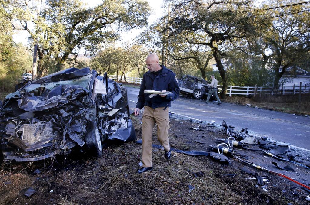 CHP Lieutenant Ken Roberts investigates the scene of a head-on collision on Highway 12 that killed a woman driver and critically injured a child and another driver in Agua Caliente, on Tuesday, Nov. 14, 2017. (BETH SCHLANKER/ PD)