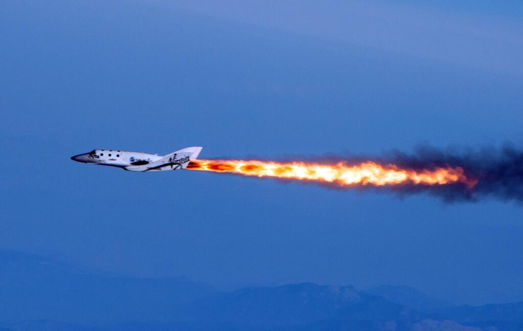 In this April 29, 2013 file photo provided by Virgin Galactic shows Virgin Galactic's SpaceShipTwo under rocket power, over Mojave, Calif. Virgin Galactic has reported an unspecified problem during a test flight of its SpaceShipTwo space tourism rocket. The company tweeted Friday, Oct. 31, 2014, morning that SpaceShipTwo was flying under rocket power and then tweeted that it had 'experienced an in-flight anomaly.' The tweet said more information would be forthcoming. (AP Photo/Virgin Galactic, Mark Greenberg, File)