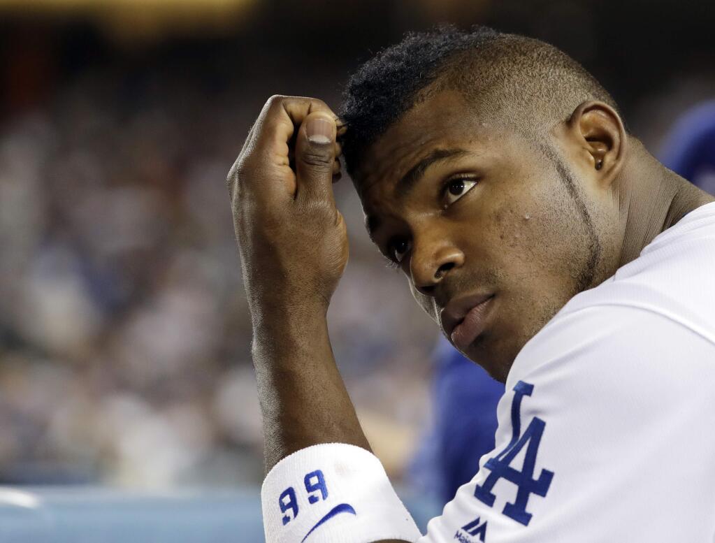 FILE - This Nov. 1, 2017 file photo shows Los Angeles Dodgers outfielder Yasiel Puig during the second inning of Game 7 of baseball's World Series against the Houston Astros in Los Angeles. During the game, which the Dodgers ultimately lost 5-1, burglars broke into Puig's home in the Encino neighborhood of Los Angeles' San Fernando Valley. Police report that officers answered a burglary alarm Wednesday evening and found a smashed window with several items taken. (AP Photo/Matt Slocum, File)