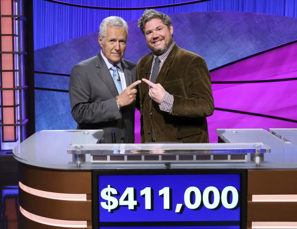 This image released by Jeopardy Productions, Inc. shows 'Jeopardy!' host Alex Trebek, left, and contestant Austin Rogers, whose 12-game winning streak came to an end on Thursday's broadcast. Rogers finished his run in fifth place on the all-time regular-season (non-tournament), winning $411,000. (Carol Kaelson/Jeopardy Productions, Inc. via AP)