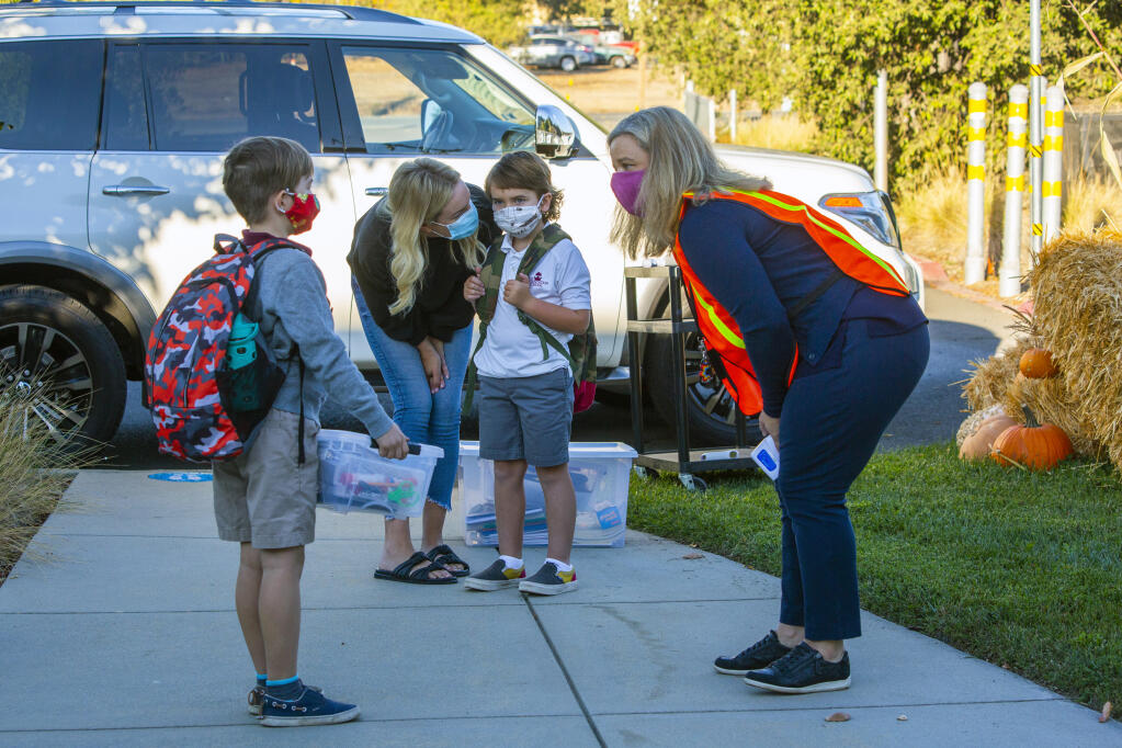 Jacqueline Gallo, right, head of school for The Presentation School on Broadway, greeted students for their first day of in-class instruction on Wednesday, Oct. 21. (Photo by Robbi Pengelly/Index-Tribune)