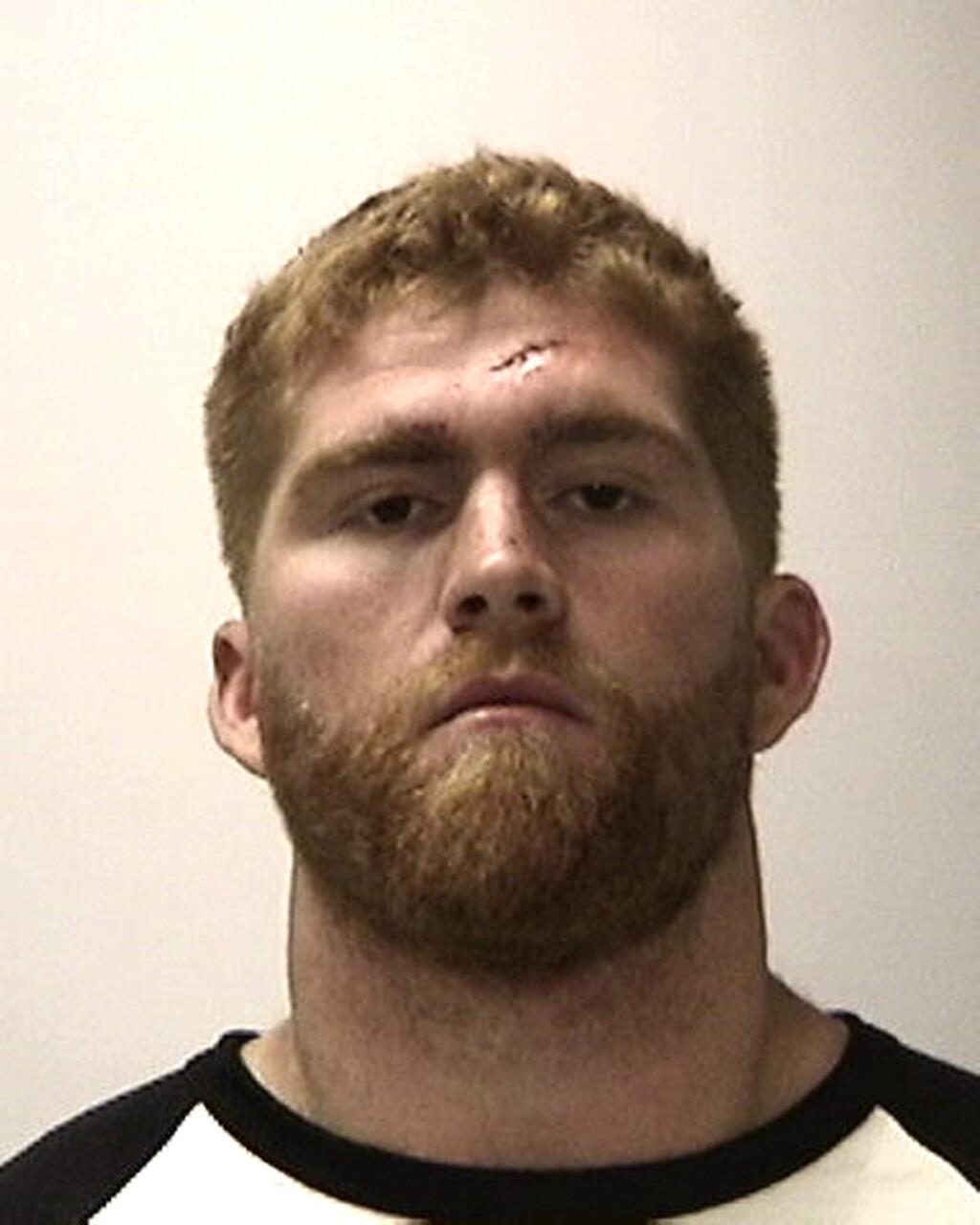 A booking photo provided by the San Francisco Police Department shows San Francisco 49ers fullback Bruce Miller. The 49ers released Miller on Monday, just hours after he was arrested for assaulting two men. Miller was charged with aggravated assault, elder abuse, threats and battery after an early-morning fight at a San Francisco hotel, according to the San Francisco Police Department. Miller was booked into county jail. (San Francisco Police Department via AP)