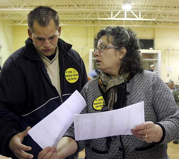 Homeless census volunteer Luke Owens looks over census areas with Jenny Abramson at the Samuel L. Jones Hall which served as a headquarters for the Santa Rosa part of the count. January 23, 2009 The Press Democrat / Jeff Kan Lee