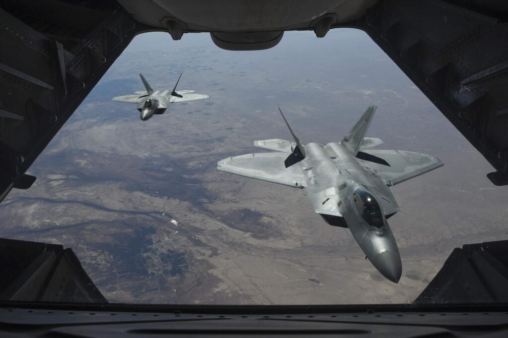 A U.S. Air Force photo shows two F-22 Raptor fighter jets as seen from another plane above Syria. (COLTON ELLIOTT / U.S. Air Force)