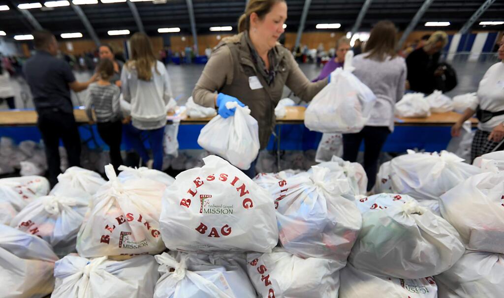 Blessing bags filled with food items were available to those that attended services at The Great Thanksgiving Banquet put on by the Redwood Gospel Mission at the Sonoma County Fairgrounds, Wednesday Nov. 22, 2017 in Santa Rosa. (Kent Porter / Press Democrat) 2017