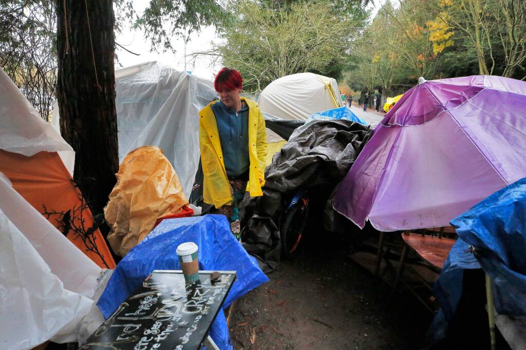 Nicholle Vannucchi stands beside the tent she lives in with her fiancŽ at the homeless encampment along Joe Rodota Trail in Santa Rosa, California, on Wednesday, December 4, 2019. (Alvin Jornada / The Press Democrat)