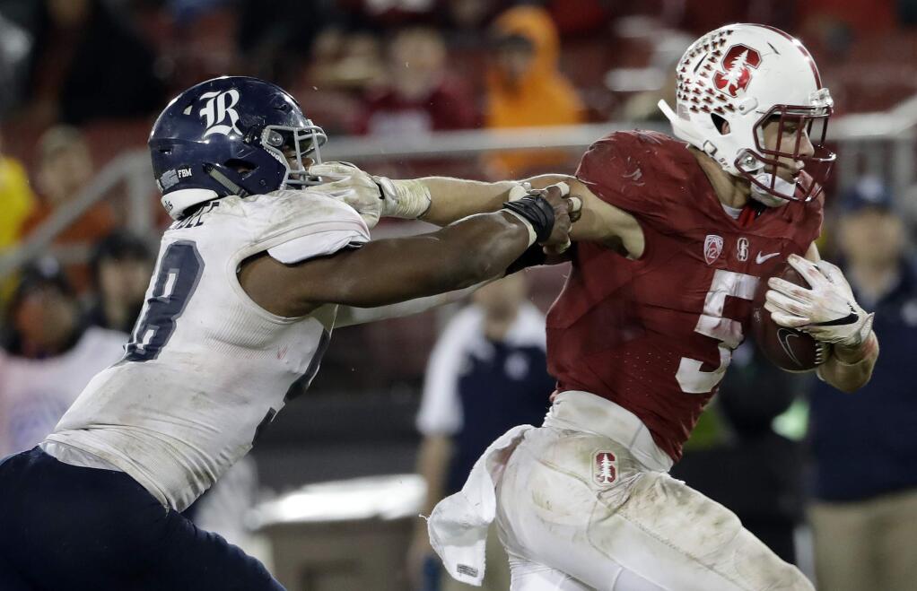 Stanford running back Christian McCaffrey, right, runs past Rice linebacker Emmanuel Ellerbee on rushing touchdown during the second half of an NCAA college football game Saturday, Nov. 26, 2016, in Stanford, Calif. (AP Photo/Marcio Jose Sanchez)