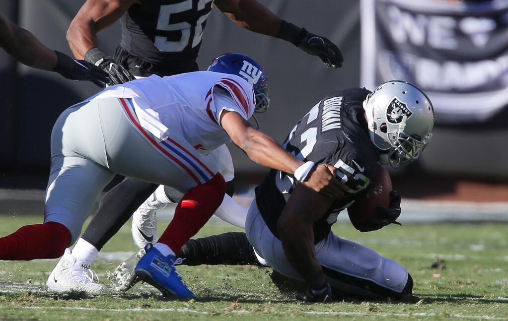Oakland Raiders linebacker recovers a fumble by the New York Giants during their game in Oakland on Sunday, December 3, 2017. The Oakland Raiders defeated the New York Giants 24-17.(Christopher Chung/ The Press Democrat)