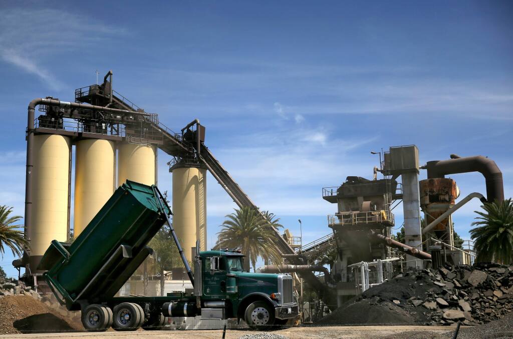 A dump truck unloads dirt and rock at the BoDean Company asphalt plant in Santa Rosa on Monday, June 10, 2019. (BETH SCHLANKER/ The Press Democrat)